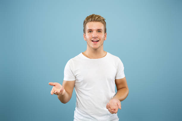 istock Caucasian young man's half-length portrait on blue background 1177227793