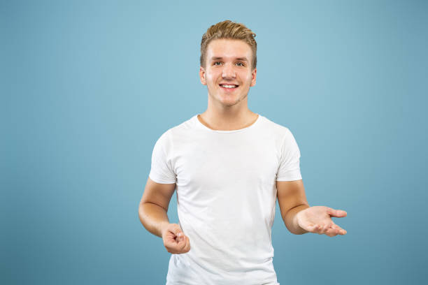 istock Caucasian young man's half-length portrait on blue background 1177227805
