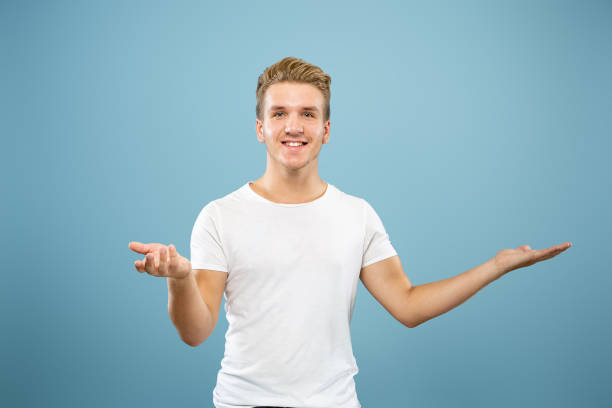 istock Caucasian young man's half-length portrait on blue background 1177227819