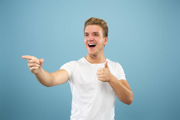 istock Caucasian young man's half-length portrait on blue background 1177227876