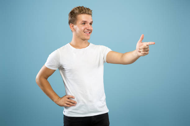 istock Caucasian young man's half-length portrait on blue background 1177227877
