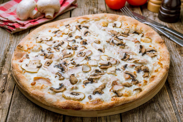 istock Pizza with chicken and mushrooms on wooden table 1177227906