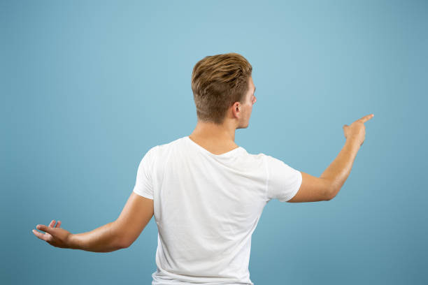 istock Caucasian young man's half-length portrait on blue background 1177227925