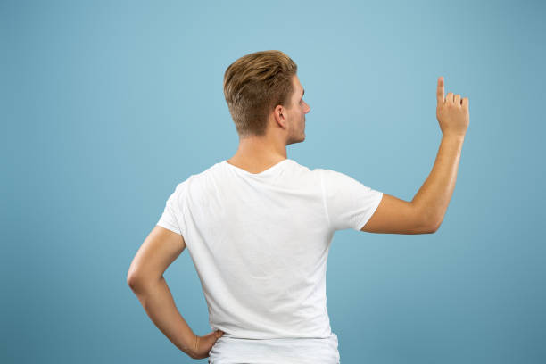 istock Caucasian young man's half-length portrait on blue background 1177227933