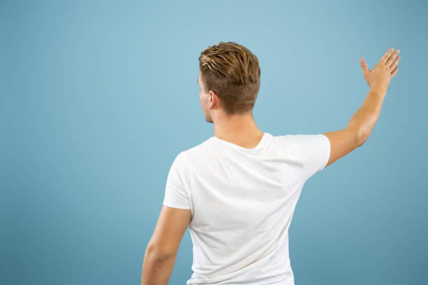 istock Caucasian young man's half-length portrait on blue background 1177227935
