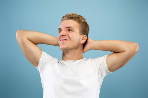 istock Caucasian young man's half-length portrait on blue background 1177227959
