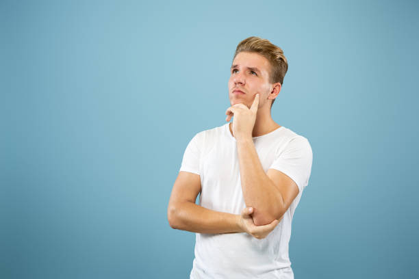 istock Caucasian young man's half-length portrait on blue background 1177227982