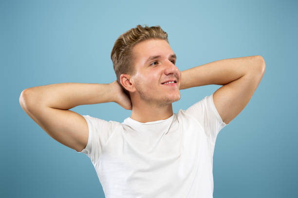 istock Caucasian young man's half-length portrait on blue background 1177227995