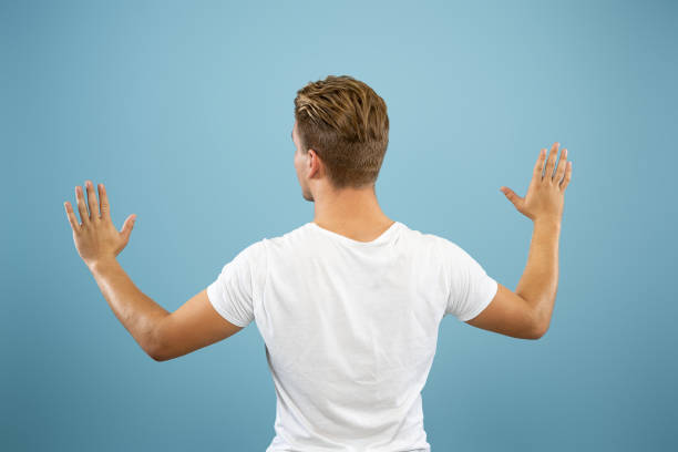 istock Caucasian young man's half-length portrait on blue background 1177228002
