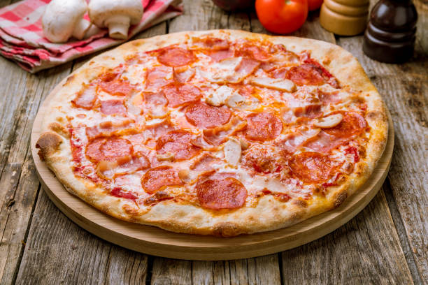 istock Italian meat pizza on wooden table 1177228011