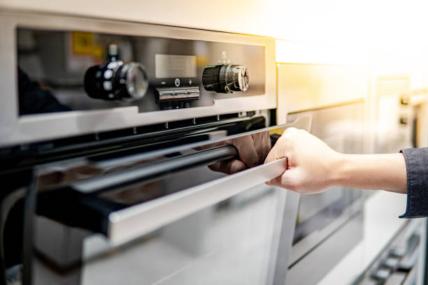 istock Male hand opening oven door 1177228076