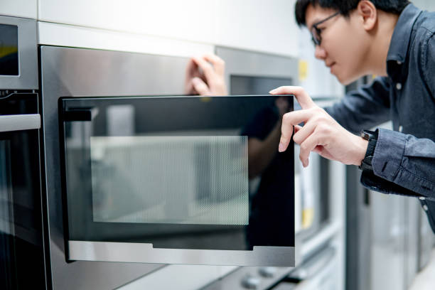 istock Asian man opening microwave door 1177229053