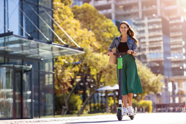 istock Female commuter riding electric push scooter 1177229243