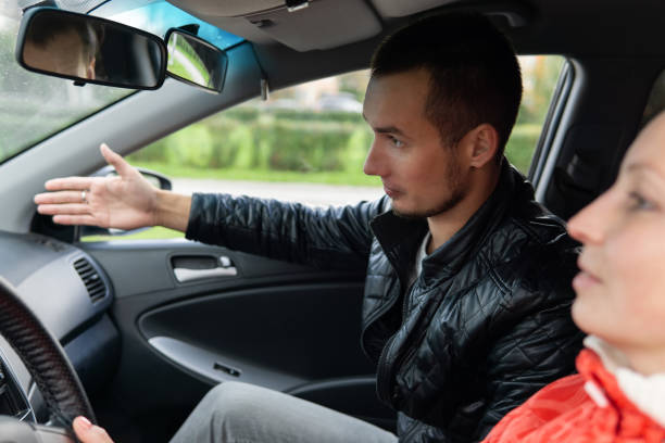 istock driving instructor teaches a student to drive a car 1177229418