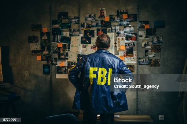 Mature Fbi Agent Works On A Case Alone Stock Photo - Download Image Now - Detective, FBI, Criminal Investigation