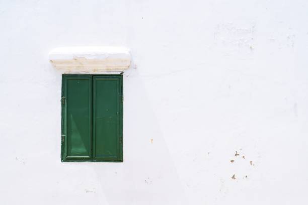 istock green wooden closed window On a white wall house 1177231679