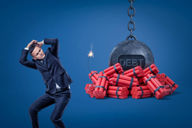 istock Businessman protecting himself with hands and chained ball with a 