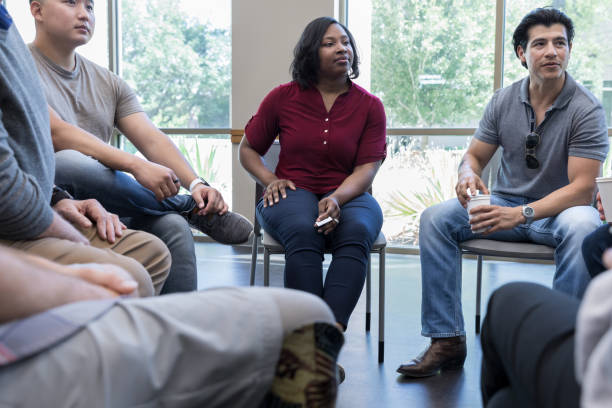 istock Attentive group of people in support group 1177233314