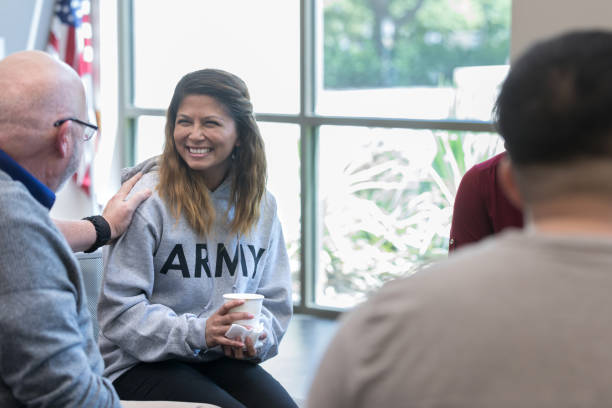 istock Older veteran reassures young veteran during therapy session 1177233323