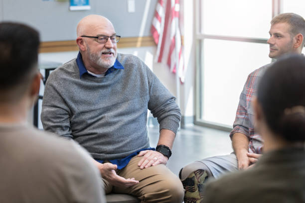 istock Therapist gives advice to veterans during therapy session 1177233348