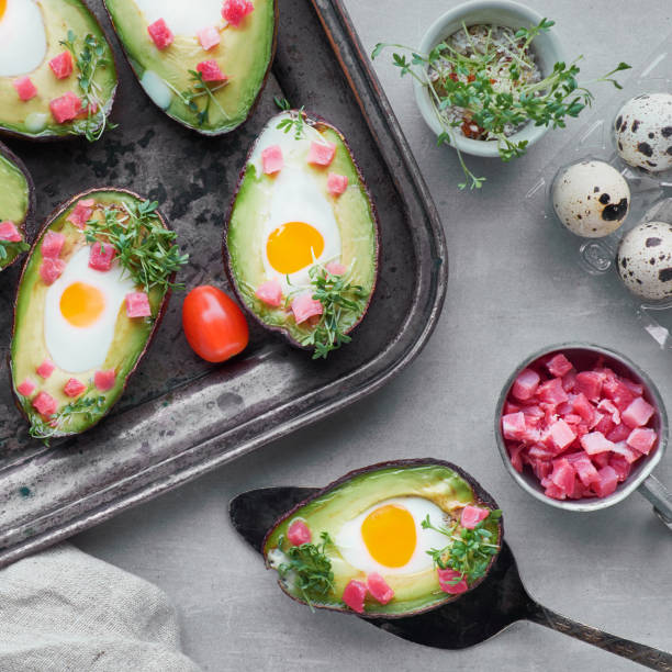 istock Keto diet dish: Avocado boats with ham cubes, quail eggs and cherry tomatoes 1177235257