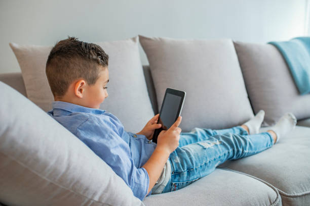 istock Little boy reading an ebook. 1177235570