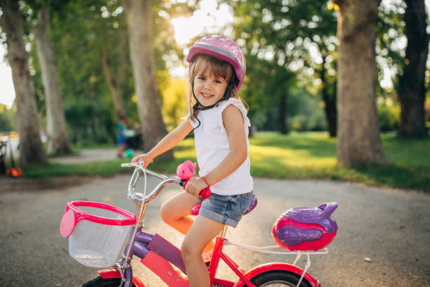 istock Little girl riding bicycle in park 1177237428