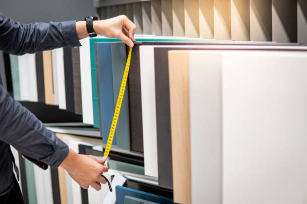 istock Male hand using tape measure on cabinet materials 1177239575