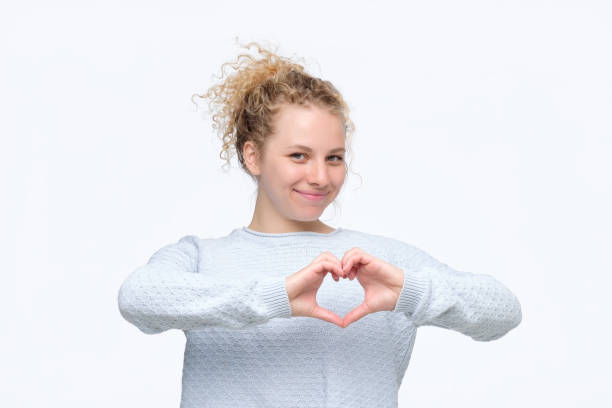 istock Smiling cheerful happy young woman making heart sign with hands 1177241646