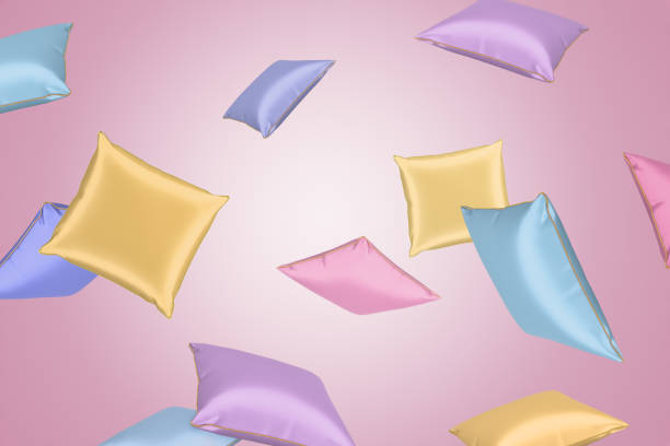 representación en 3d de coloridas almohadas de satén volando sobre fondo de color rosa claro. - cushion pillow textile luxury fotografías e imágenes de stock