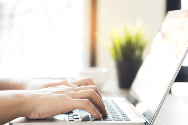 istock Man hands typing on laptop keyboard with sun light in the morning. 1177243633