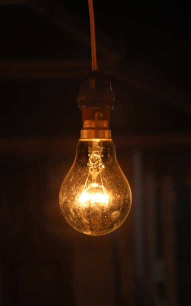 istock Old light bulbs shine in the darkness - images 1177243861