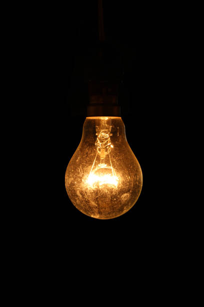 istock Old light bulbs shine in the darkness - images 1177243943