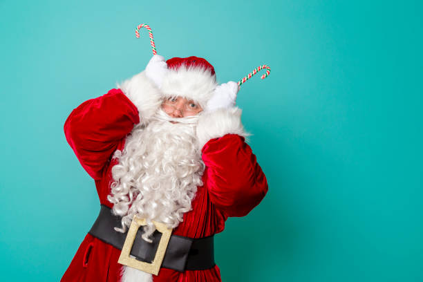 istock Santa Claus holding candy cane antlers 1177244340