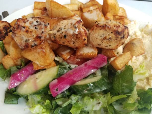 istock chicken on a stick with sauce and potato and lettuce 1177245363