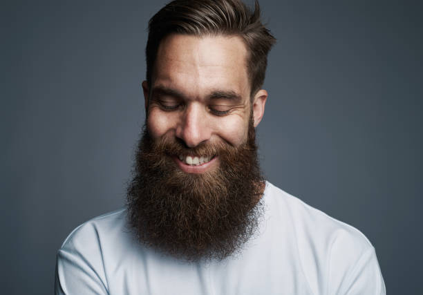 istock Stylish young man standing against a gray background 1177246246
