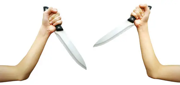 Photo of Human hand holding Stainless steel kitchen knife for fighting or murder.