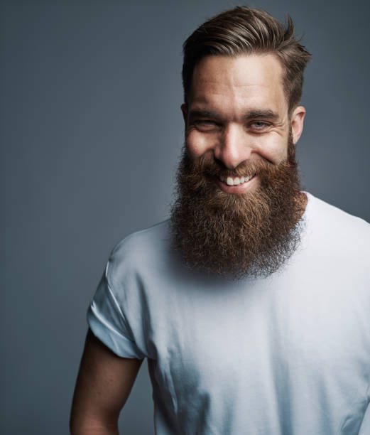 istock Bearded young man laughing against a gray background 1177246676