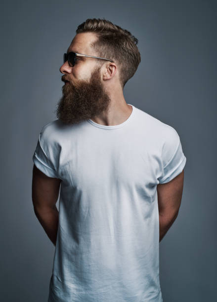 istock Stylish young man with a beard wearing sunglasses looking sideways 1177246697