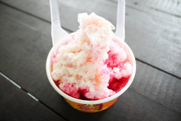 istock Ice snow dessert with plastic spoon on wooden floor 1177246775