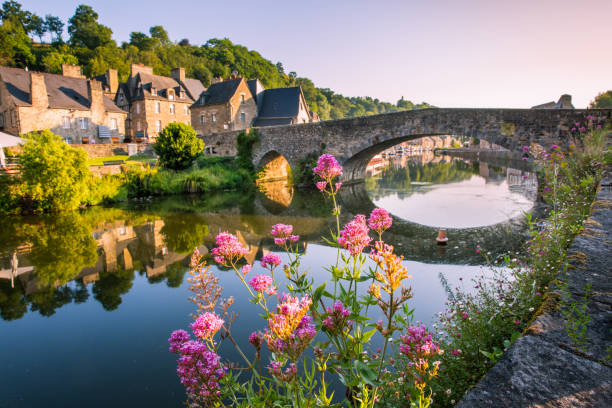 Dinan Old Medieval Bridge and Stone Houses Reflecting in Rance River in Bretagne, Cotes d'Armor, France Dinan Old Medieval Bridge and Stone Houses Reflecting in Rance River in Bretagne, Cotes d'Armor, France brittany france stock pictures, royalty-free photos & images