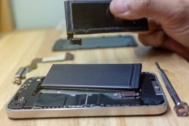 istock Iphone repairs install battery into the motherboard for smartphone By technician on desk 1177248758