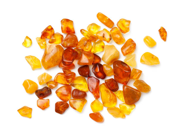 Ambers Isolated On White Background Ambers isolated on white background. Pieces of polished amber. Top view, flat lay amber stock pictures, royalty-free photos & images