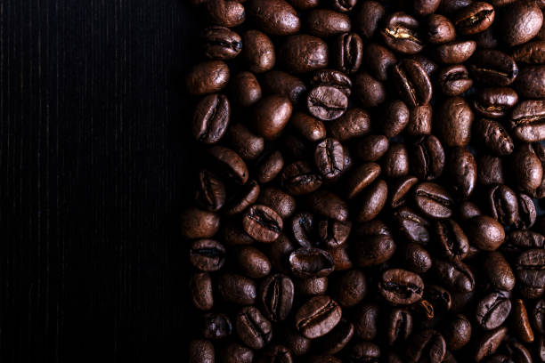 Coffee beans on wooden background. Macro.