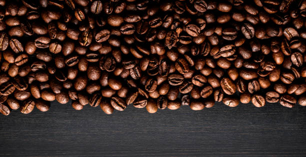 istock Coffee beans on wooden background. Macro. 1177250813