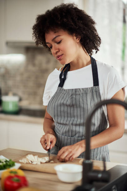 istock Mixed race woman chopping mushrooms. 1177252384