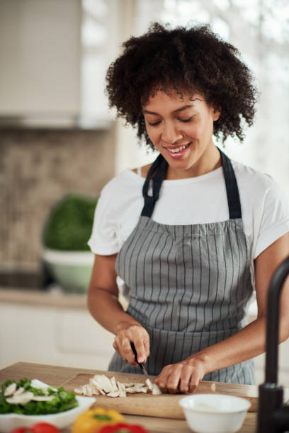 istock Mixed race woman chopping mushrooms. 1177252945