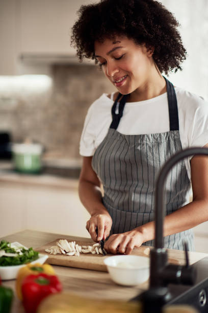 istock Mixed race woman chopping mushrooms. 1177252975