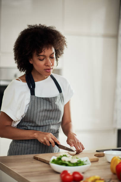 istock Mixed race woman chopping mushrooms. 1177253032