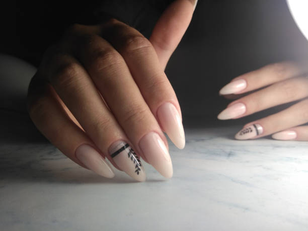 istock Long nails with manicure and camouflage finish with black twig design. 1177255037